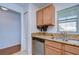 Kitchen features double sink, granite counters, and wood cabinets at 37650 Aaralyn Rd, Zephyrhills, FL 33542