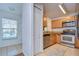 Kitchen features wood cabinets, granite counters, and stainless steel appliances at 37650 Aaralyn Rd, Zephyrhills, FL 33542