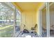 Screened patio with an exercise bike and access to backyard at 37650 Aaralyn Rd, Zephyrhills, FL 33542