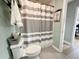 Clean bathroom with shower/tub combo and gray and white decor at 3909 W Eden Roc Cir, Tampa, FL 33634