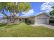 Single-story home with a landscaped lawn and attached garage at 3909 W Eden Roc Cir, Tampa, FL 33634