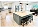 Modern kitchen featuring an island, stainless steel appliances, and light wood flooring at 3909 W Eden Roc Cir, Tampa, FL 33634
