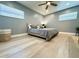 Main bedroom with light wood floors and a ceiling fan at 3909 W Eden Roc Cir, Tampa, FL 33634