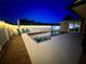 Inviting pool area with string lights and patio seating at night at 3909 W Eden Roc Cir, Tampa, FL 33634