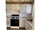 Small kitchen with white cabinets and appliances at 6025 Shore S Blvd # 405, Gulfport, FL 33707