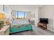 Bright bedroom with window, carpet and a TV at 6322 Palma Del Mar S Blvd # 705, St Petersburg, FL 33715