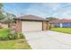 Brick home with attached garage and a large yard at 6424 Silver Oaks Dr, Zephyrhills, FL 33542