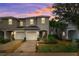 Two-story townhome with attached garage and landscaped front yard at 7016 Summer Holly Pl, Riverview, FL 33578