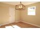 Bright dining room with hardwood floors and a stylish light fixture at 7160 Lenape Cir, New Port Richey, FL 34653