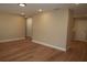 Bright hallway with hardwood floors and neutral-colored walls at 7160 Lenape Cir, New Port Richey, FL 34653