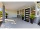 Covered front porch with modern door and potted plants at 7326 12Th N Ave, St Petersburg, FL 33710