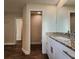 Main bathroom with granite countertop, white cabinets, and tile flooring at 8610 Quinn Ct, North Port, FL 34287
