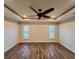 Bright bedroom with wood-look floors, high ceiling and ceiling fan at 8610 Quinn Ct, North Port, FL 34287