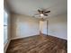 Large bedroom with wood floors and door to hallway at 8610 Quinn Ct, North Port, FL 34287