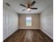 Spacious bedroom featuring wood-look floors and a ceiling fan at 8610 Quinn Ct, North Port, FL 34287