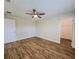 Well-lit bedroom with wood-look floors and ceiling fan at 8610 Quinn Ct, North Port, FL 34287