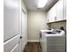 Laundry room with washer, dryer, and additional cabinets at 8610 Quinn Ct, North Port, FL 34287