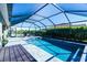 Inviting screened-in pool area with lounge chairs and a wooden deck at 8610 Quinn Ct, North Port, FL 34287