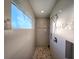 Walk-in shower with pebble tile accents and large window at 8610 Quinn Ct, North Port, FL 34287