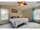 Main bedroom with carpeted floor, large bed, and ample natural light at 8727 Huntfield St, Tampa, FL 33635