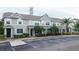 Exterior of two-story townhome featuring fresh paint, and landscaping, plus nearby parking at 8796 Christie Dr, Largo, FL 33771