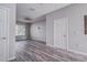 Bright living room featuring wood floors, a ceiling fan, and natural light from a large window at 8796 Christie Dr, Largo, FL 33771