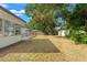 Spacious backyard with mature trees and a large grassy area at 936 Lyndhurst St, Dunedin, FL 34698