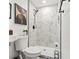Modern bathroom with marble shower and white toilet at 936 Lyndhurst St, Dunedin, FL 34698