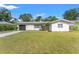 House with a neatly landscaped front yard and driveway at 936 Lyndhurst St, Dunedin, FL 34698