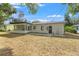 Back of the house, featuring a patio and fenced yard at 936 Lyndhurst St, Dunedin, FL 34698