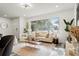 Spacious living area with comfy seating and large windows at 936 Lyndhurst St, Dunedin, FL 34698