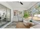Relaxing sunroom with comfy chairs and backyard view at 936 Lyndhurst St, Dunedin, FL 34698