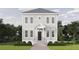 Two-story house with gray siding, black door, and manicured lawn at 100 37Th Ne Ave, St Petersburg, FL 33704