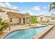 Relaxing backyard oasis featuring a freeform pool and pergola at 10829 Breaking Rocks Dr, Tampa, FL 33647