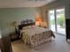 Main bedroom with sliding glass doors leading to the patio at 1139 Woodleaf Ct, Palm Harbor, FL 34684