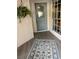 Inviting front entry with light grey door and decorative rug at 1139 Woodleaf Ct, Palm Harbor, FL 34684