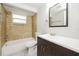 Updated bathroom with a tub, toilet and vanity at 1172 Fernwood Dr, Holiday, FL 34690