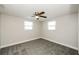 Bright bedroom featuring new carpet and ceiling fan at 1172 Fernwood Dr, Holiday, FL 34690