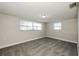 Well lit bedroom featuring carpet and two large windows at 1172 Fernwood Dr, Holiday, FL 34690