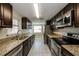 Modern kitchen with granite countertops and stainless steel appliances at 1172 Fernwood Dr, Holiday, FL 34690