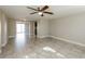 Bright living room featuring tile floors and a ceiling fan at 1172 Fernwood Dr, Holiday, FL 34690