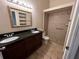 Bathroom features double vanity, granite countertop and shower at 11847 Skylake Pl # D, Tampa, FL 33617