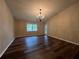 Bright dining room with laminate flooring and chandelier at 11847 Skylake Pl # D, Tampa, FL 33617