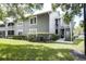 Gray condo building with exterior stairs and landscaping at 11847 Skylake Pl # D, Tampa, FL 33617