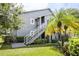 Gray condo building with exterior stairs and landscaping at 11847 Skylake Pl # D, Tampa, FL 33617