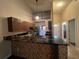 Kitchen with granite countertops and dark brown cabinets at 11847 Skylake Pl # D, Tampa, FL 33617