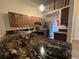 Kitchen with granite countertops and dark brown cabinets at 11847 Skylake Pl # D, Tampa, FL 33617