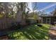 Artificial turf backyard with fire pit and wooden fence at 120 89Th Ne Ave, St Petersburg, FL 33702