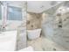 Elegant bathroom with marble finishes, double vanity and free-standing tub at 120 89Th Ne Ave, St Petersburg, FL 33702