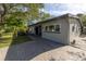 Updated mid-century modern home with a paved driveway and landscaping at 120 89Th Ne Ave, St Petersburg, FL 33702